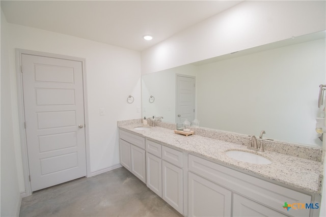 bathroom with vanity and concrete floors