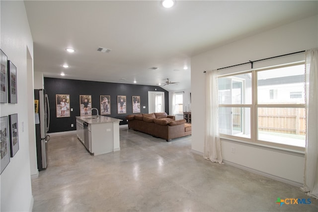 interior space featuring a healthy amount of sunlight, sink, and ceiling fan