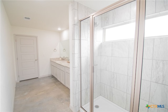 bathroom featuring an enclosed shower, vanity, and concrete floors