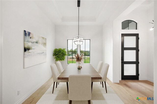 1123 Vintage Way, New Braunfels, TX 78132 - dining room with light wood finished floors, a raised ceiling, and a chandelier