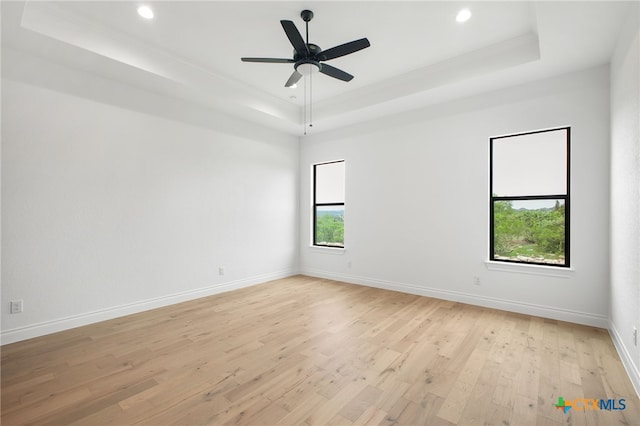 1123 Vintage Way, New Braunfels, TX 78132 - unfurnished room with a tray ceiling, light wood-style floors, recessed lighting, a ceiling fan, and crown molding