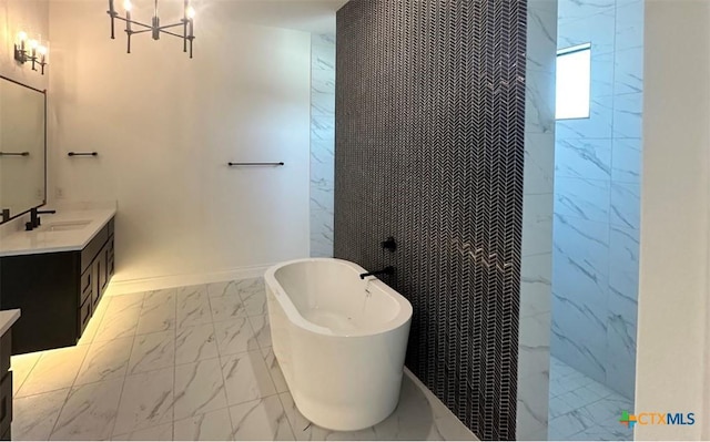 bathroom with a walk in shower, vanity, baseboards, a freestanding bath, and marble finish floor