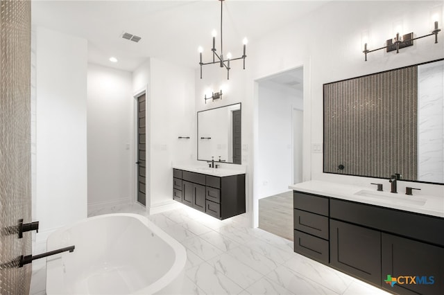 1123 Vintage Way, New Braunfels, TX 78132 - full bathroom with two vanities, a freestanding tub, recessed lighting, a chandelier, and marble finish floors