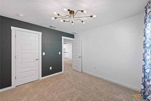 unfurnished bedroom featuring carpet, baseboards, a chandelier, and visible vents