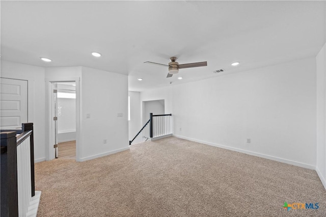 interior space with baseboards, visible vents, recessed lighting, and light colored carpet