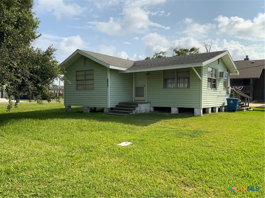 back of house with a lawn