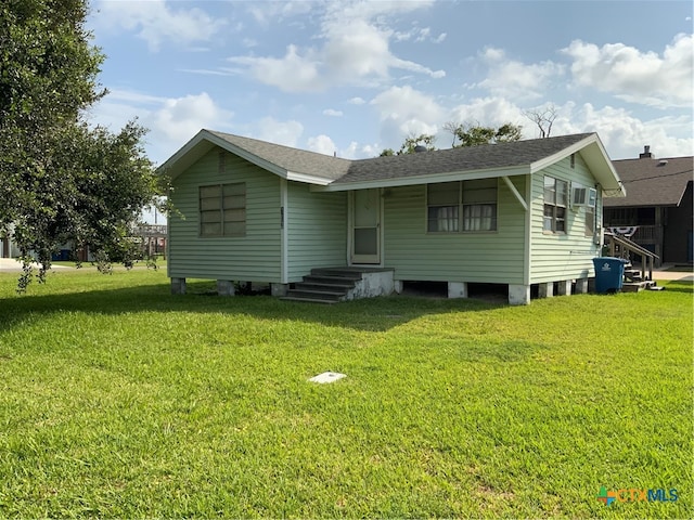 back of house with a lawn