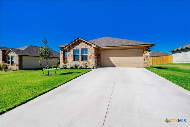 view of front of house featuring a front lawn and a garage