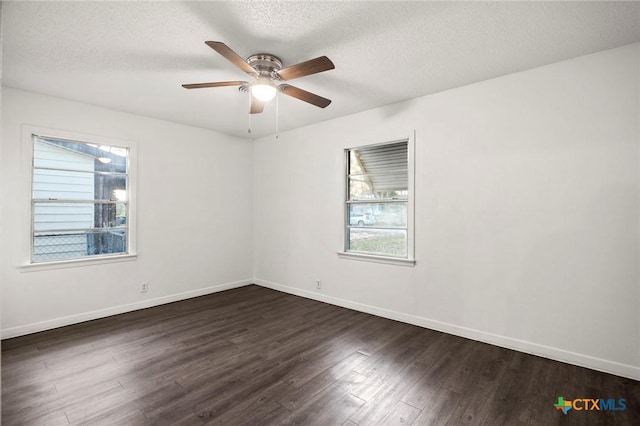 empty room with a textured ceiling, ceiling fan, and dark wood-type flooring