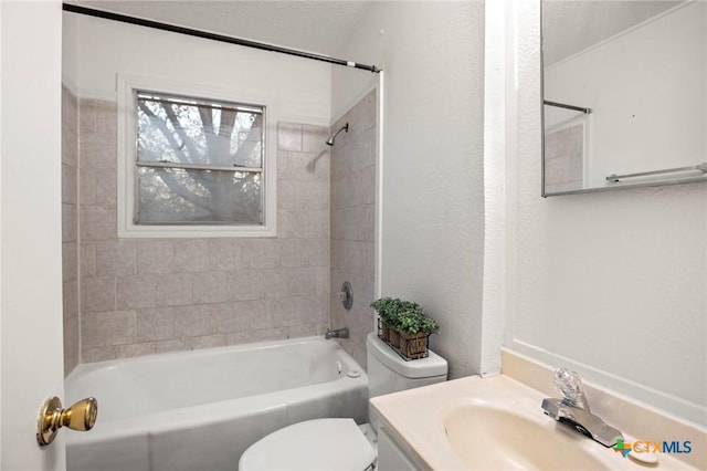 full bathroom with vanity, toilet, and tiled shower / bath