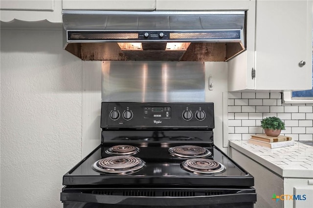 kitchen with white cabinets, backsplash, and black range with electric cooktop