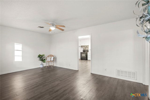 unfurnished room featuring ceiling fan and dark hardwood / wood-style flooring