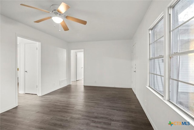 unfurnished room featuring dark hardwood / wood-style floors and ceiling fan