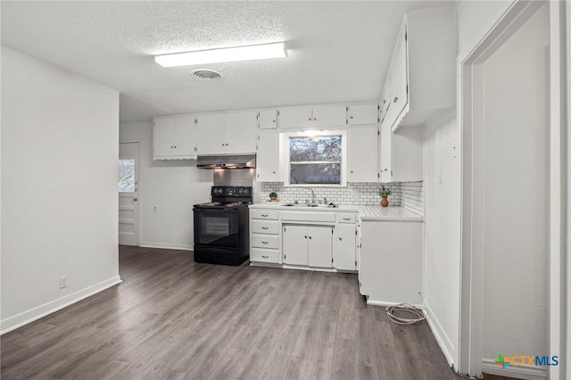 kitchen with white cabinets, black electric range oven, sink, and a textured ceiling