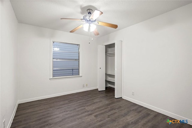 unfurnished bedroom featuring ceiling fan, dark hardwood / wood-style flooring, and a closet