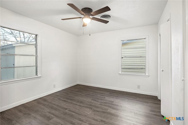 empty room featuring ceiling fan and dark wood-type flooring