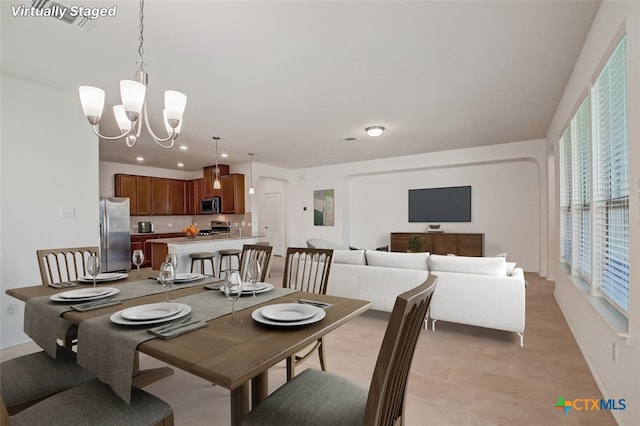 dining area featuring an inviting chandelier