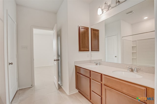 bathroom with tile patterned flooring and vanity