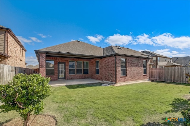 back of property featuring a yard and a patio area