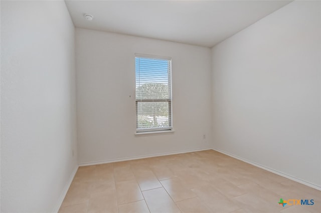 spare room featuring light tile patterned flooring