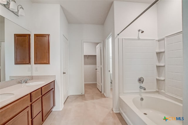 bathroom with vanity, tile patterned floors, and  shower combination