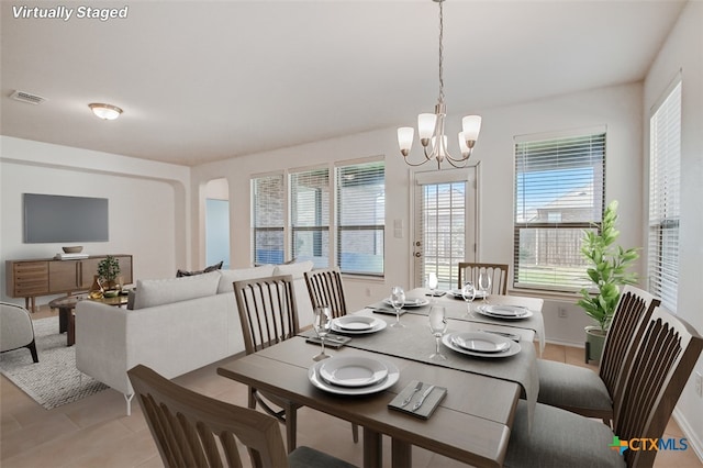 dining space featuring a notable chandelier