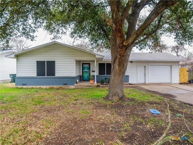 single story home featuring a garage and a front lawn