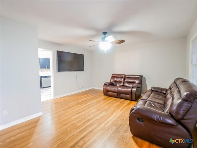 living room featuring hardwood / wood-style floors and ceiling fan