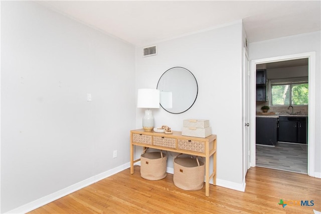 1902 S 41st St, Temple, TX 76504 - hall featuring light wood-style floors, a sink, and baseboards