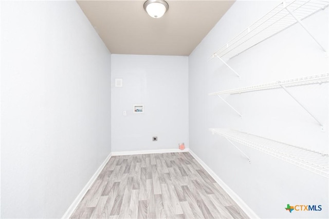 1902 S 41st St, Temple, TX 76504 - laundry area featuring hookup for a washing machine, electric dryer hookup, wood finished floors, and baseboards