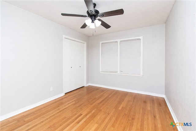 1902 S 41st St, Temple, TX 76504 - unfurnished bedroom featuring light wood-type flooring, baseboards, a closet, and a ceiling fan