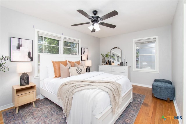 1902 S 41st St, Temple, TX 76504 - bedroom with hardwood / wood-style flooring, baseboards, and a ceiling fan