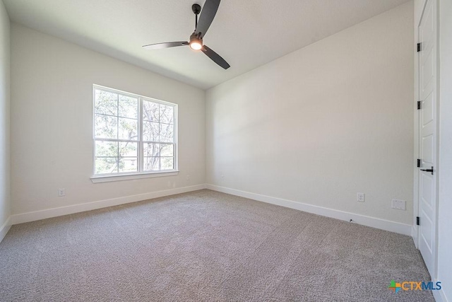unfurnished room with a ceiling fan, light carpet, and baseboards