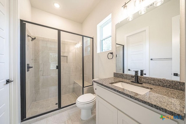 bathroom featuring a shower stall, toilet, vanity, and tile patterned flooring