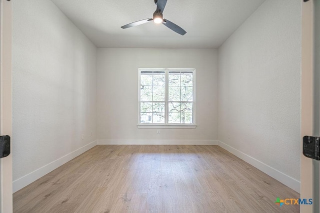 unfurnished room featuring light wood-type flooring, ceiling fan, and baseboards