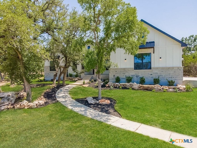 view of front of house featuring board and batten siding and a front lawn