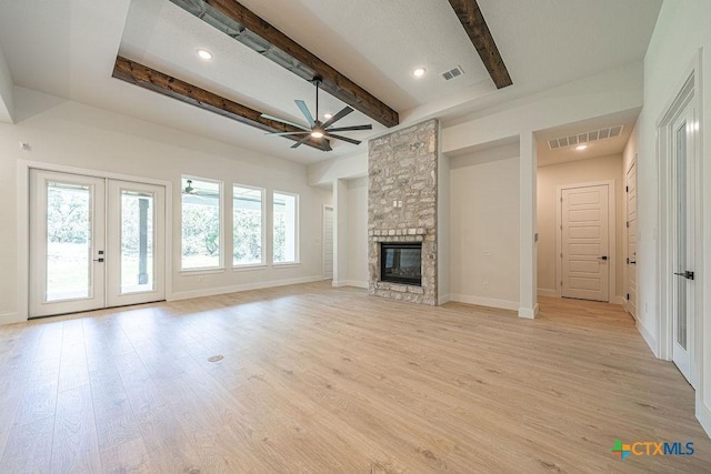 unfurnished living room with beam ceiling, french doors, ceiling fan, light wood-type flooring, and recessed lighting