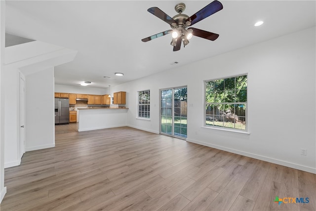 unfurnished living room featuring light hardwood / wood-style floors and ceiling fan