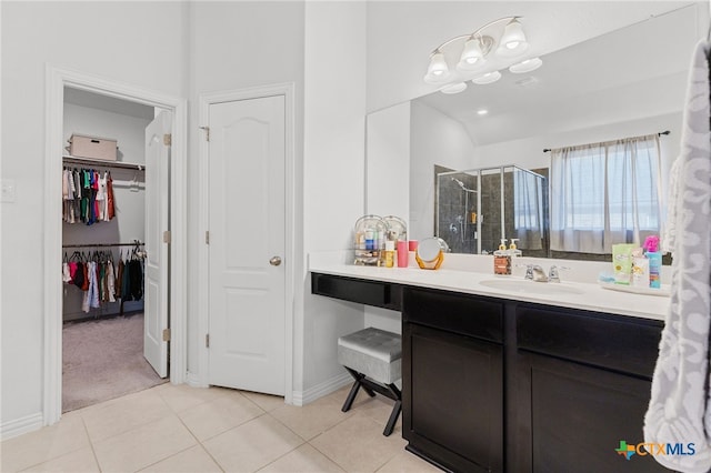 427 Bluejack Way, Hutto, TX 78634 - full bathroom with a stall shower, tile patterned flooring, vanity, a spacious closet, and baseboards