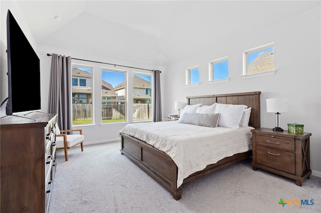427 Bluejack Way, Hutto, TX 78634 - bedroom with light colored carpet, vaulted ceiling, and baseboards