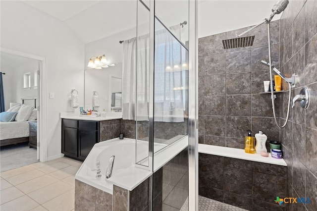 427 Bluejack Way, Hutto, TX 78634 - ensuite bathroom with a shower stall, tile patterned flooring, vanity, a bath, and vaulted ceiling