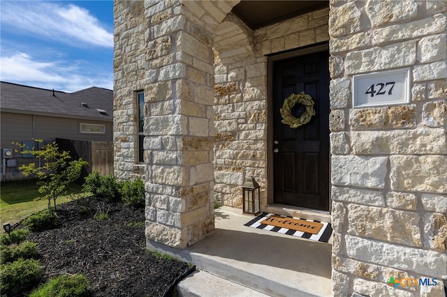 427 Bluejack Way, Hutto, TX 78634 - property entrance with stone siding and fence