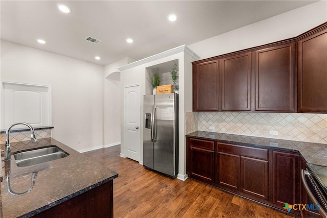 7805 Northgate Loop, Temple, TX 76502 - kitchen featuring stainless steel appliances, dark stone countertops, dark wood-style flooring, decorative backsplash, and recessed lighting