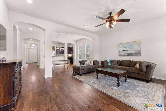 7805 Northgate Loop, Temple, TX 76502 - living room featuring arched walkways, a ceiling fan, dark wood-type flooring, recessed lighting, and a chandelier