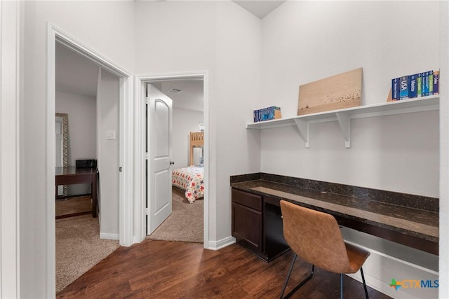 7805 Northgate Loop, Temple, TX 76502 - office space with built in study area, dark wood-type flooring, and dark colored carpet
