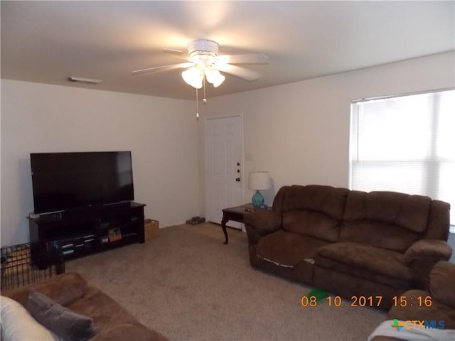 living room with a ceiling fan and carpet