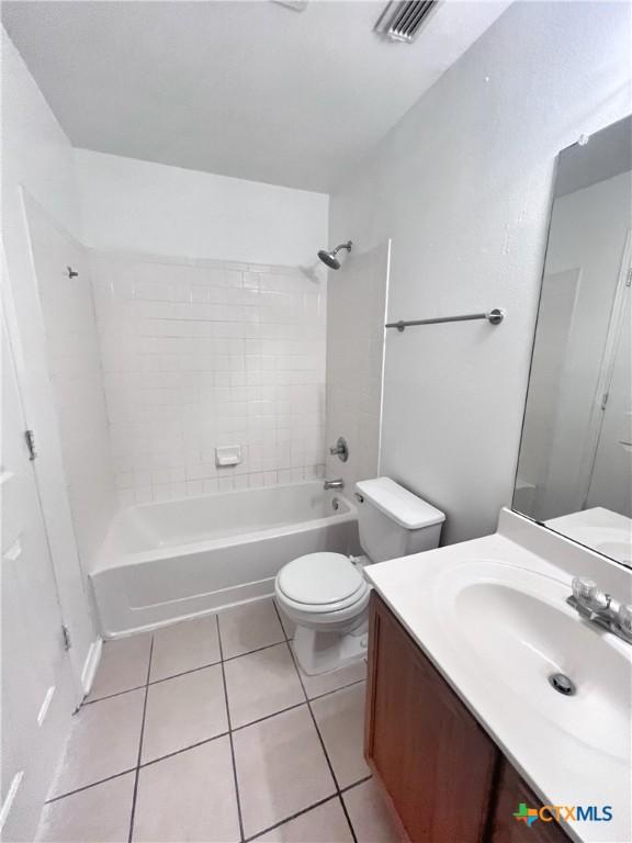 bathroom with tile patterned flooring, visible vents, toilet, shower / bath combination, and vanity