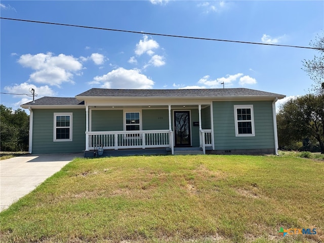 ranch-style home with a front yard and covered porch