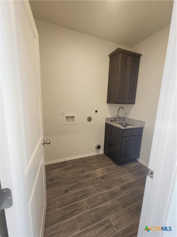 6002 Monza Dr, Temple, TX 76502 - laundry room with washer hookup, dark wood-style flooring, and cabinet space