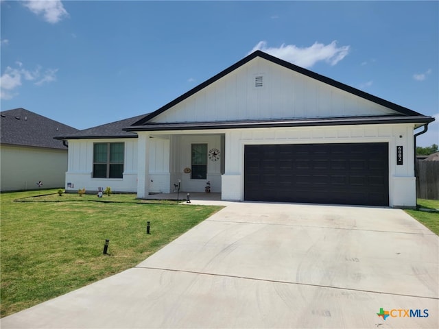 6002 Monza Dr, Temple, TX 76502 - view of front of property featuring board and batten siding, concrete driveway, an attached garage, and a front lawn